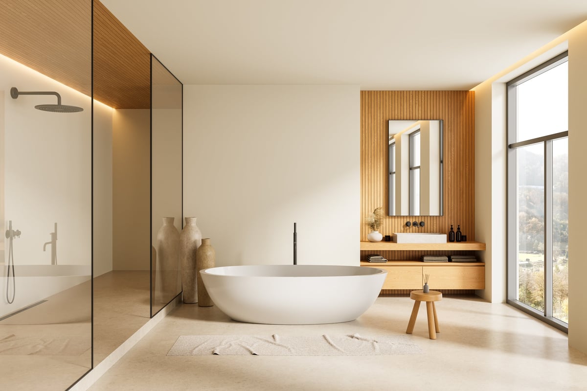 Elegant modern bathroom with white freestanding tub, wood panels, and beige decor, with natural lighting from a large window